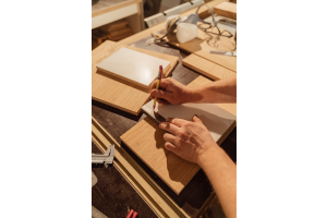 man drawing over softwood skirting board for measurements